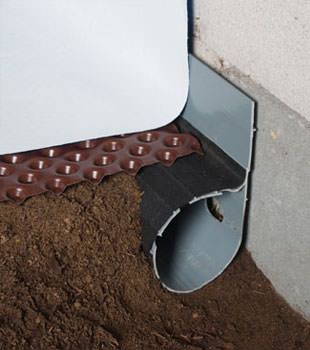 Closeup of a crawl space drainage system installed in Oracle