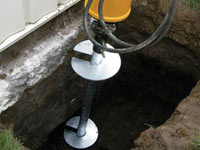 Installing a helical pier system in the earth around a foundation in Green Valley