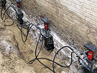 Using foundation push piers to lift a foundation during a repair in Sahuarita.