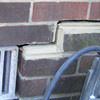A closeup of a failed tuckpointing job where the brick cracked on a Rillito home.