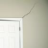 A long drywall crack beginning at the corner of a doorway in a Hereford home.