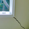 A long, diagonal crack that begins at a window corner of a Safford home