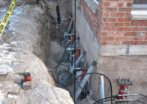 Foundation push piers installed around a house with a foundation settlement issues in Oracle