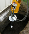 Installing a helical pier during a foundation repair in Green Valley